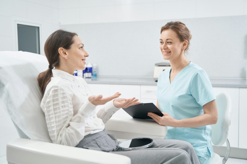 Woman having consultation with cosmetologist in beauty clinic